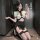 Woman in golden night air hostess uniform lingerie - seductive police-themed sexy outfit, posing with phone.
