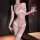 Woman wearing golden night floral lace lingerie set with push-up bra, matching panty, and lace thigh-highs, holding a wine gl...