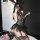 Woman posing in black lace golden night sexy bunny girl lingerie set with garters, sheer bodice, and bunny ears headband.