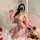 A woman poses on a bed wearing a pink golden night sexy lingerie set, featuring a retro princess belly dance bodice with lace...