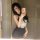 A woman poses in a black and white dress featuring lace details and heart cutouts, capturing a selfie in a mirror. the outfit...