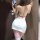 A woman poses in a white sheer dress with red accents, featuring a back cutout and thigh-high pink stockings, perfect for cos...