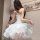 A woman models a white dress with ruffled layers, perfect for a bunny girl costume ideal for halloween events or nightclub pe...