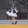 A stylish individual wears a black and white gothic lolita maid dress, perfect for halloween and cosplay events. the outfit f...