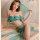 Vintage -inspired green silk belly dance costume with flowing fabric and gold accents, perfect for cosplay and performance.
