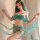 Vintage-inspired green silk belly dance costume featuring a flowing headscarf and sequined belt, perfect for cosplay and perf...