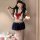A stylish girl wearing a gufei sexy schoolgirl costume set, featuring a sailor top with a red bow, a pleated skirt, and thigh...