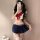 A stylish individual poses in a gufei sexy schoolgirl costume set, featuring a sailor top with a large red bow and a pleated ...