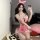 A woman poses with a phone, wearing a pink sensual lingerie set inspired by shen miao wei qing. the outfit features bunny ear...