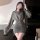 Woman wearing a gray hong kong style flirty lingerie dress with ruffled bodycon mini skirt and waist-cinching design.