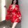 A woman poses in a red japanese cherry blossom-themed sleepwear set, featuring a kimono-style design with floral patterns. th...