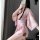 A woman poses with a smartphone, wearing a pink japanese cherry blossom-themed kimono-style sleepwear set. the outfit feature...