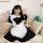 A woman poses wearing a japanese cute bunny maid cosplay dress, featuring black and white colors with lace details and a larg...