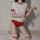 A woman models a japanese gymnastics outfit, featuring a white top with red trim, red shorts, and striped knee-high socks, pe...
