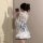 A woman models a delicate japanese-inspired sensual lingerie set, featuring a floral kimono-style sleepwear with a soft bow d...