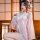 Woman wearing pink japanese kawaii bunny kimono robe with lace trim, bow, and floral print—sexy yet sweet lingerie set in tra...