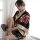 A woman elegantly poses wearing a japanese kimono-style lingerie set, featuring vibrant floral patterns and flowing fabric, p...