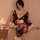 A woman poses elegantly in a black floral japanese kimono-style lingerie set, featuring a deep v-neckline and flowing sleeves...