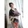 A woman wears a black floral japanese kimono-style lingerie set, holding a fan, exuding elegance and playfulness. perfect for...