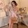 A woman elegantly poses wearing a delicate japanese kimono-style lingerie set, featuring floral patterns and a soft pink ribb...