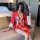 A woman elegantly poses wearing a vibrant red japanese kimono with butterfly prints, featuring a bow at the waist and lace fa...