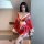 A woman wears a red japanese kimono-style lingerie with butterfly print, featuring a deep v-neckline and flowing sleeves, per...