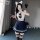 A person wearing a japanese-korean school uniform set, featuring a cute sailor collar, bunny ears, and a pleated skirt, posin...
