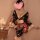 A woman wears a black floral japanese-style sheer kimono robe set, featuring a deep v-neckline and heart-shaped overlay, perf...