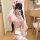 A person wearing a japanese-style lingerie set featuring a pink kimono robe with bunny ears and bow details, posing for a mir...