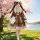 A girl in a cute japanese lolita dress stands by a cherry blossom tree, holding a plush rabbit. the brown a-line skirt featur...