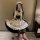 A person wearing a japanese maid costume dress, featuring black and white colors with ruffles and bows, suitable for cosplay ...