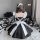 Japanese maid costume with black and white lolita dress, featuring puffy sleeves and a bow, perfect for stage performances an...