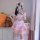 A girl wearing a cute japanese maid dress with a sweet cat theme, featuring pink and white colors, bows, and bunny ears. she ...