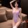 A woman poses confidently wearing a sheer bodysuit, highlighting its elegant design and form-fitting style. the open-crotch m...