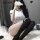 Woman posing in white sailor-style bodysuit with adjustable straps, black thigh-highs, and removable details for a sexy schoo...