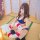 A woman poses with a lifebuoy featuring welcome to japan text, wearing a blue swimsuit set. the scene combines traditional ja...