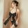 Woman wearing black satin halter bodysuit with large bow front and backless design, paired with matching thong.