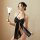 Woman wearing black satin halter bodysuit with large bow and thong, holding feather wand. backless japanese seductive lace li...