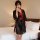 A woman stands beside a bed wearing a sheer japanese-style sensual kimono lingerie set. the robe features intricate floral em...
