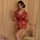 A woman poses elegantly in a japanese-style sexy lingerie set featuring a deep v neckline and floral print, paired with a mat...
