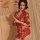 A woman elegantly poses holding a traditional parasol, wearing a vibrant red japanese-style bathrobe adorned with intricate f...