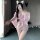A woman poses in a pink japanese-style kimono sleepwear set, featuring floral patterns and a bow tie, perfect for plus-size w...