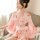 A woman wears a japanese-style sexy lingerie set, featuring a seductive kimono sleepwear with floral patterns and a soft pink...