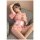A woman lounges on a couch wearing a delicate pink japanese-style robe adorned with floral patterns. the sheer ice silk fabri...