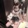 Woman in jinxiao jk sailor suit lingerie, sheer mesh bodysuit with black trim, holding teddy bear, seated by mirror.