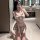 Woman in jk style lingerie set, playful plaid sleepwear for role play and mood enhancement, posing in a modern bathroom.
