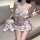 Woman in jk style lingerie set with plaid bow top and skirt, posing with teddy bear for playful seductive role play mood.