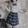 A stylish ensemble featuring a white blouse with a bow tie, paired with a blue plaid skirt, perfect for a schoolgirl look.