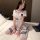 A petite woman wears a white sailor-style jk uniform set, featuring a short-sleeved top with blue accents and matching knee-h...