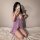 A woman poses with a phone, wearing a purple sensual lingerie set featuring lace details and ruffles. the design highlights e...